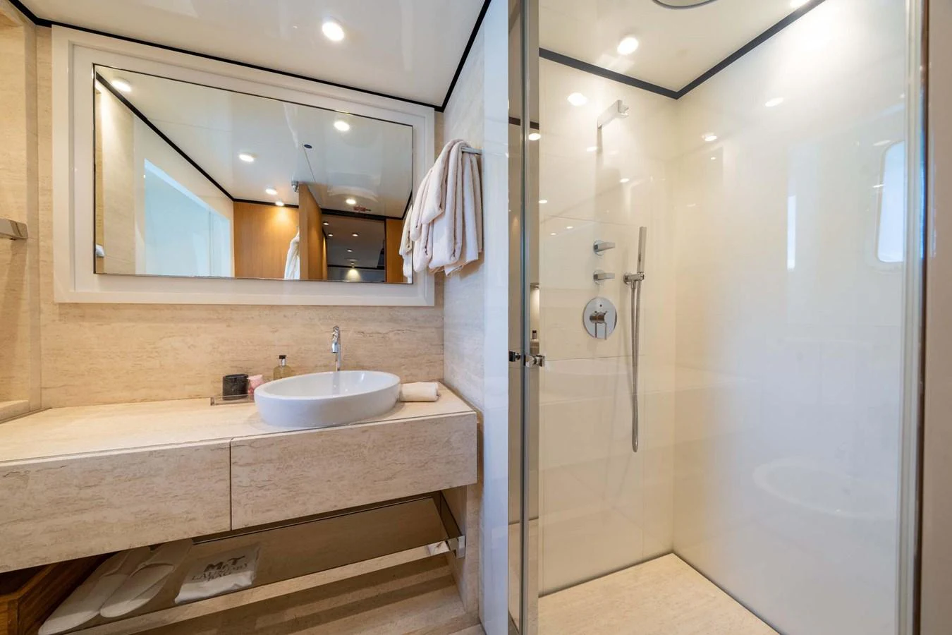 The yacht's bathroom features a modern design with a spacious shower and elegant fixtures. aboard MR. T Yacht for Sale