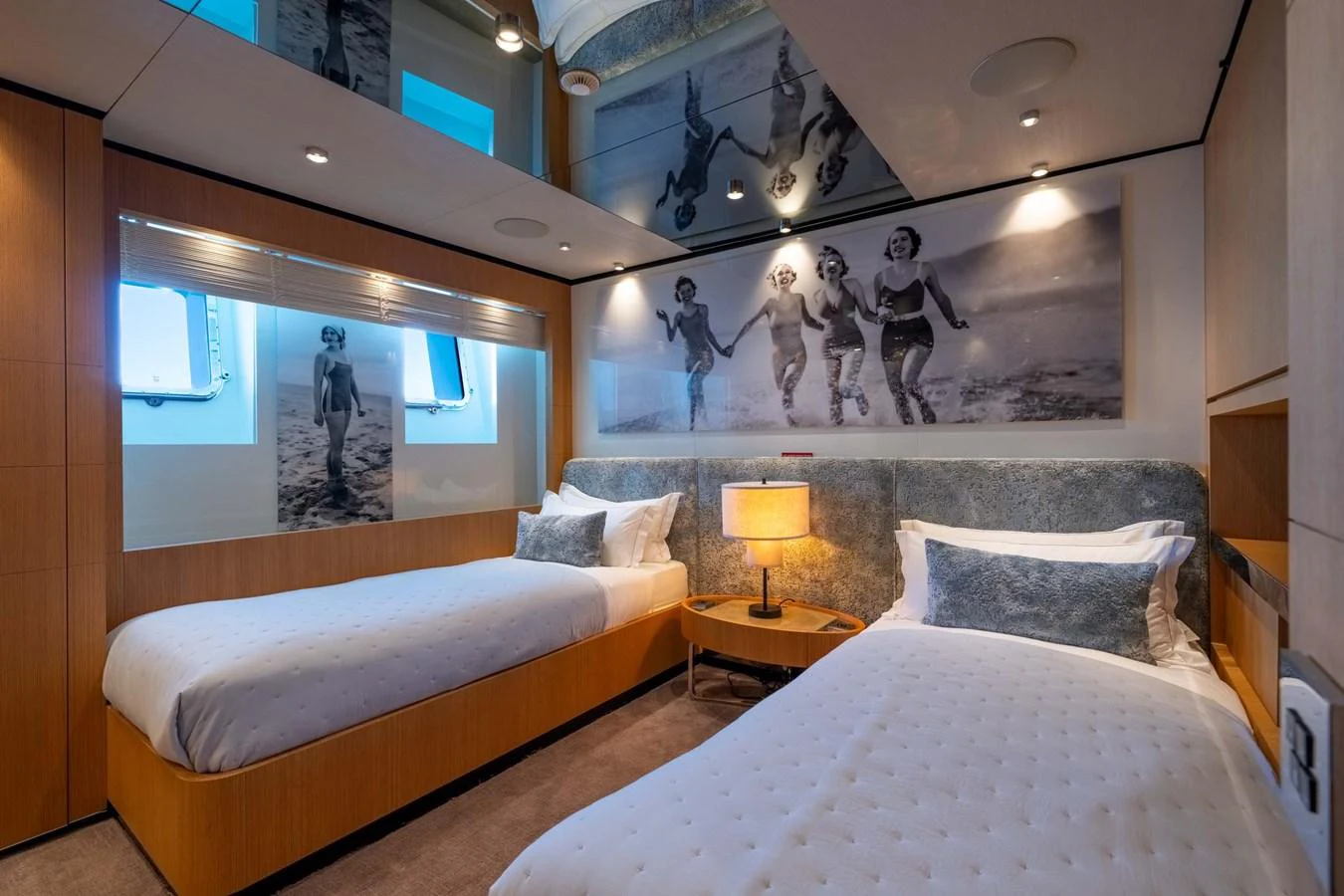 The guest stateroom features twin beds with a stylish and cozy ambiance. aboard MR. T Yacht for Sale