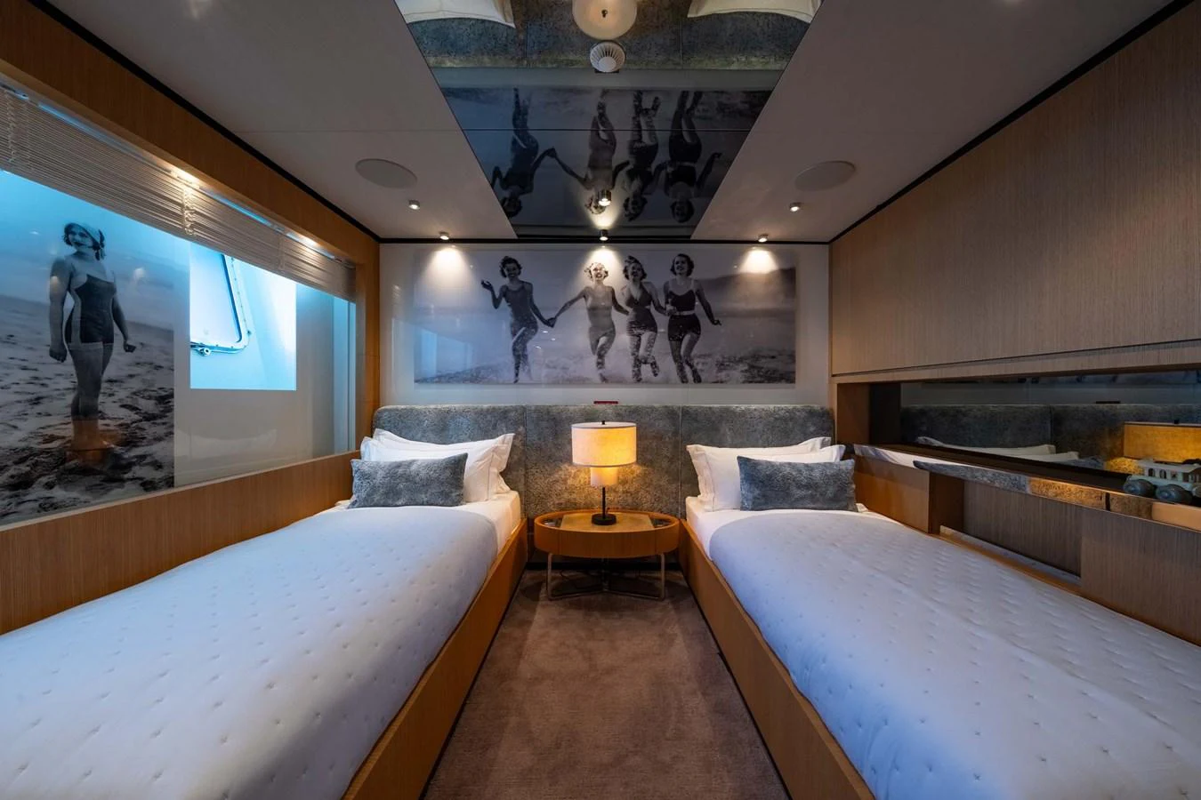 The guest stateroom features twin beds, modern decor, and a cozy ambiance. aboard MR. T Yacht for Sale