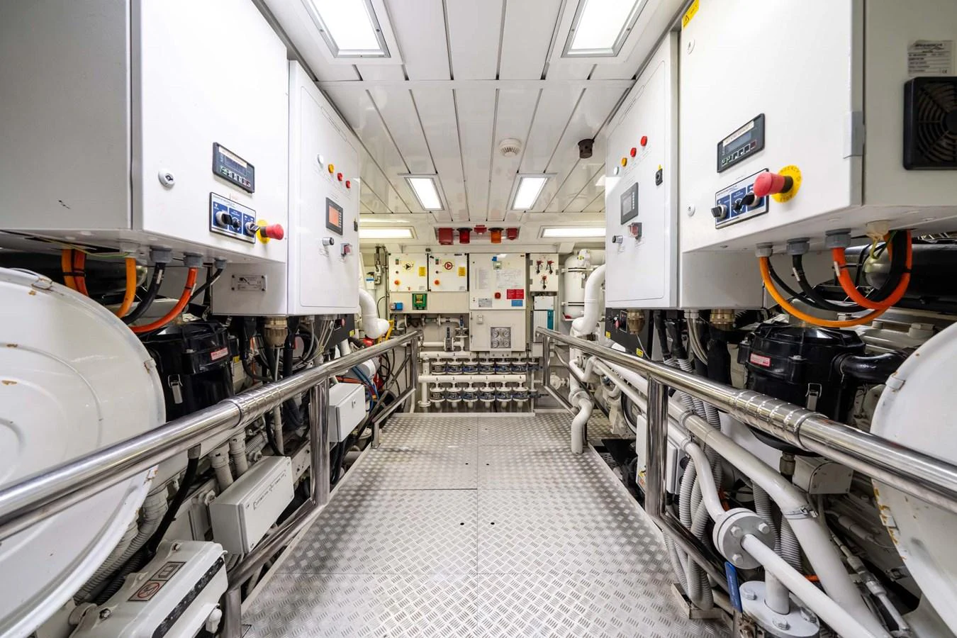 The yacht's engine room showcases a well-organized and meticulously maintained space with advanced machinery. aboard MR. T Yacht for Sale