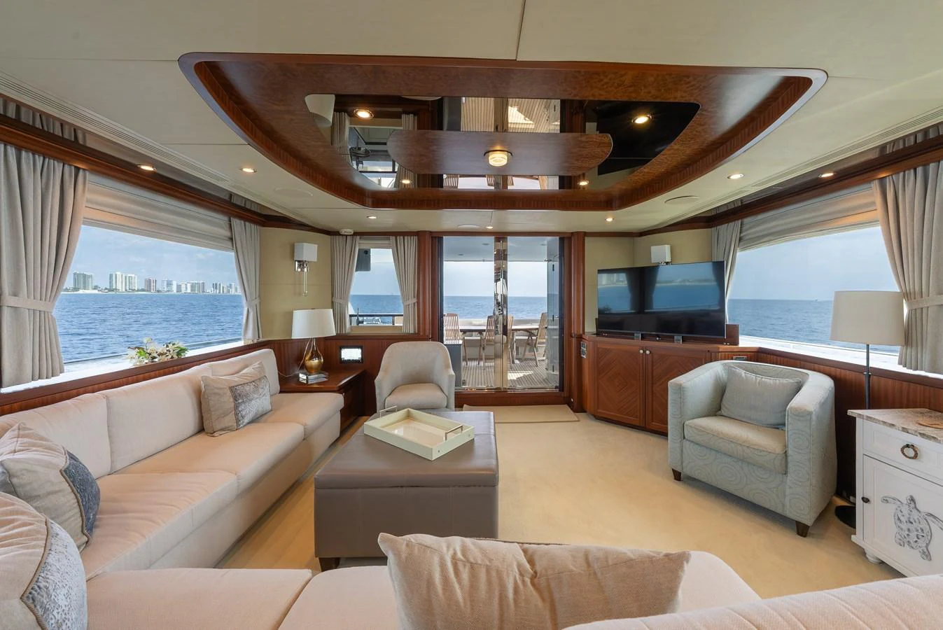 The yacht's salon offers a spacious and elegant living area with panoramic ocean views. aboard ABOAT TIME Yacht for Sale
