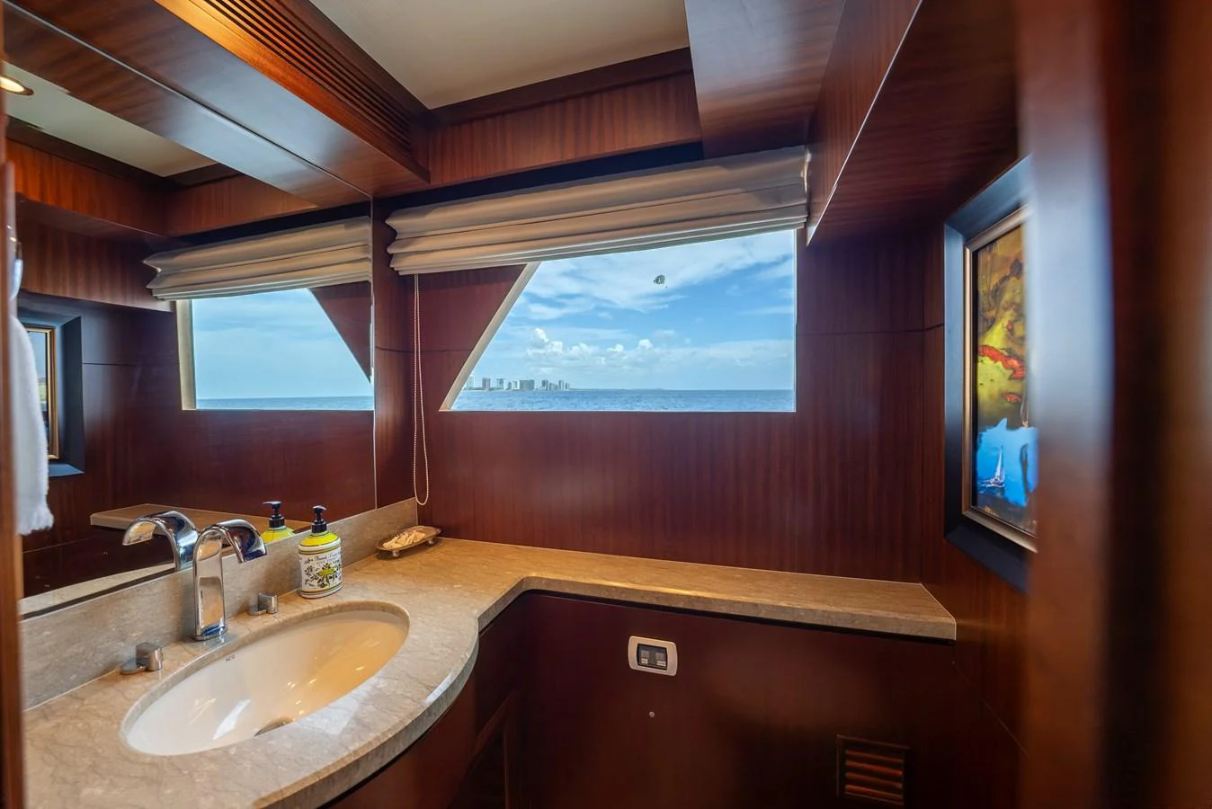 A luxurious yacht bathroom with a large window offering a stunning sea view. aboard ABOAT TIME Yacht for Sale