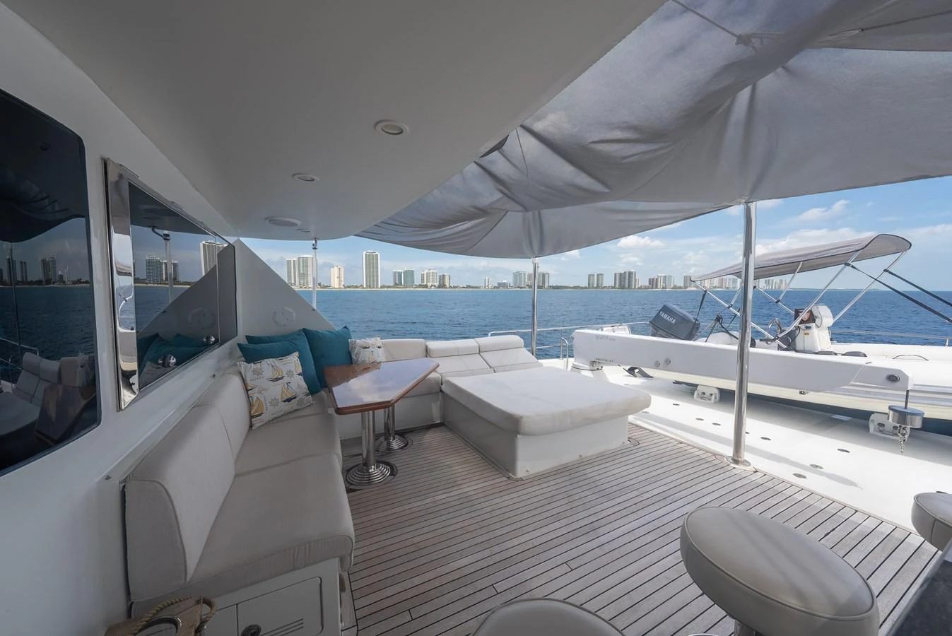 The aft deck offers a spacious and shaded lounging area with comfortable seating and stunning views of the water. aboard ABOAT TIME Yacht for Sale