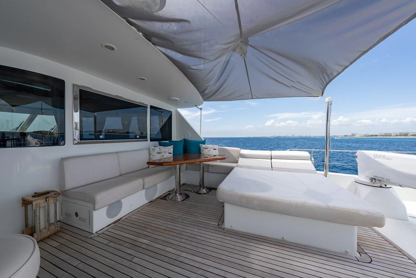 The aft deck offers a comfortable lounging area with plush seating and a shaded canopy, perfect for relaxation. aboard ABOAT TIME Yacht for Sale