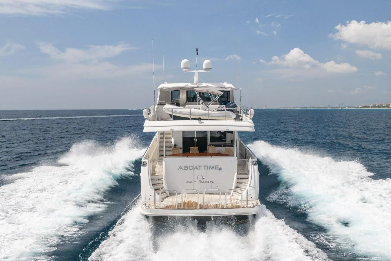 A luxurious yacht cruises through the open sea, leaving a trail of white wake behind. aboard ABOAT TIME Yacht for Sale