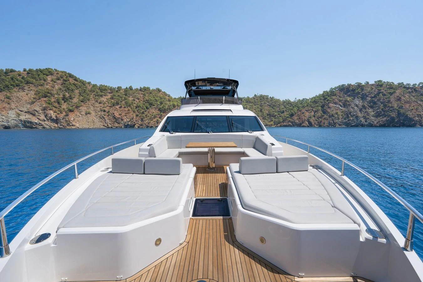 The yacht's foredeck features spacious sunbeds and a stunning view of the surrounding waters. aboard NAAMA Yacht for Sale