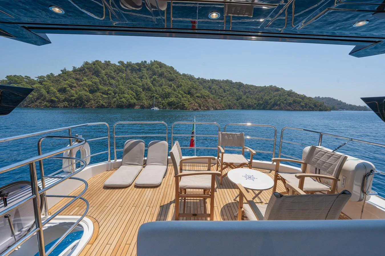 The aft deck offers a serene space with comfortable seating and sun loungers, perfect for relaxation while enjoying the scenic views. aboard NAAMA Yacht for Sale