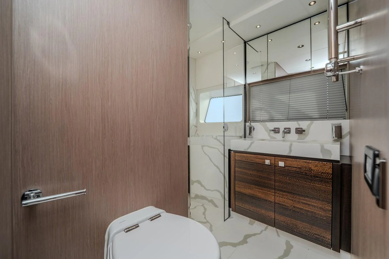 The yacht's bathroom features modern fixtures and elegant wood accents. aboard NAAMA Yacht for Sale