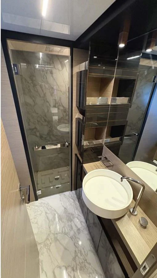A modern yacht bathroom featuring elegant marble and wood finishes. aboard ABIGAIL Yacht for Sale