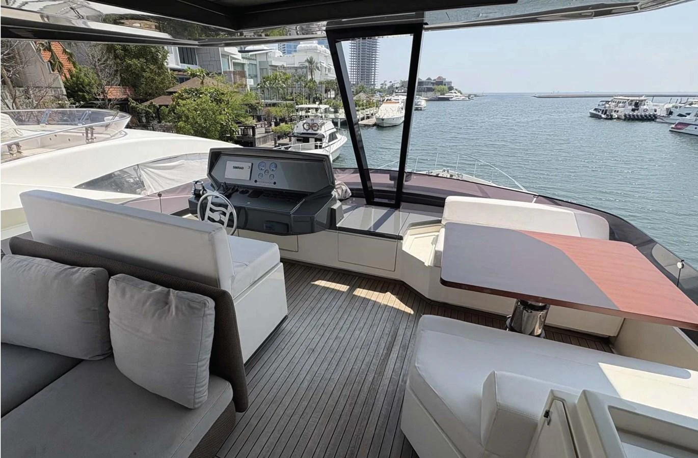 The helm area offers a comfortable seating arrangement with a view of the marina. aboard ABIGAIL Yacht for Sale