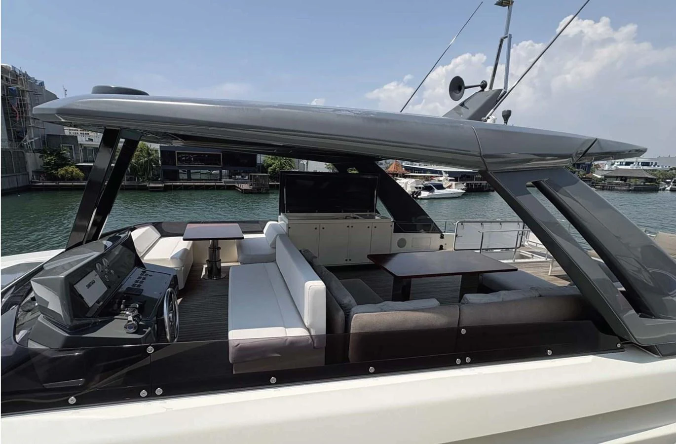 The yacht's flybridge offers a spacious and stylish outdoor seating area with modern furnishings and a helm station. aboard ABIGAIL Yacht for Sale