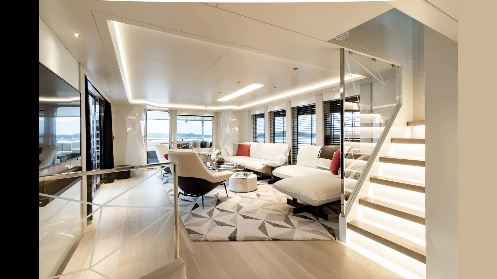 The yacht's salon offers a spacious and modern living area with ample seating and elegant lighting. aboard HULL #5 Yacht for Sale