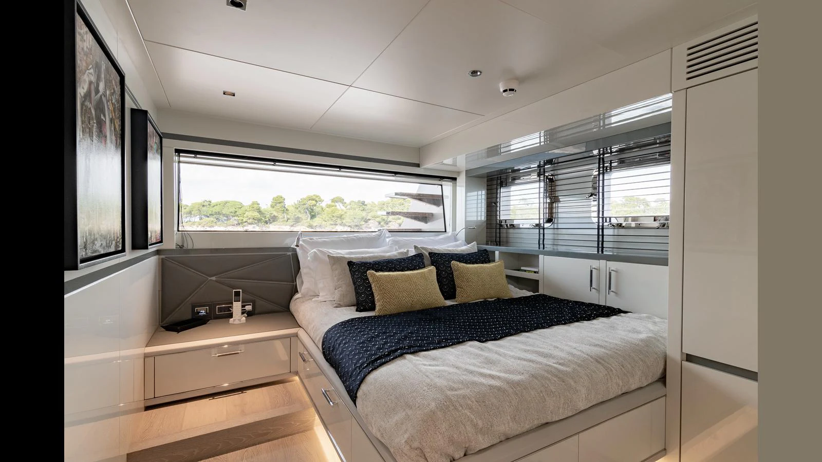 The stateroom features a luxurious bed with plush pillows and modern decor, offering a serene retreat. aboard HULL #5 Yacht for Sale