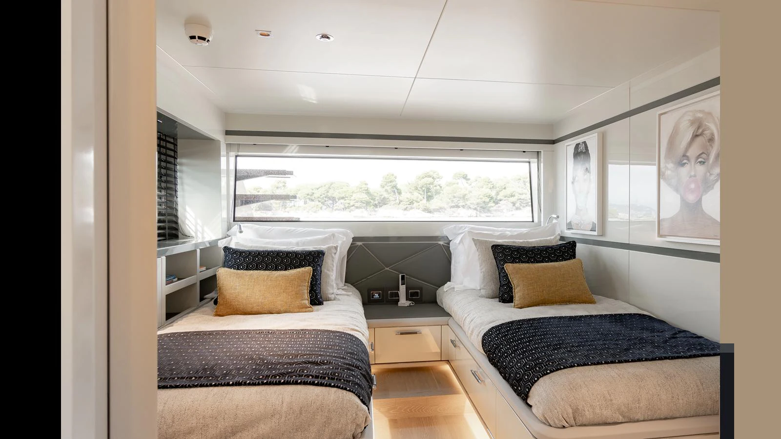 The guest stateroom features twin beds with elegant bedding and modern decor. aboard HULL #5 Yacht for Sale
