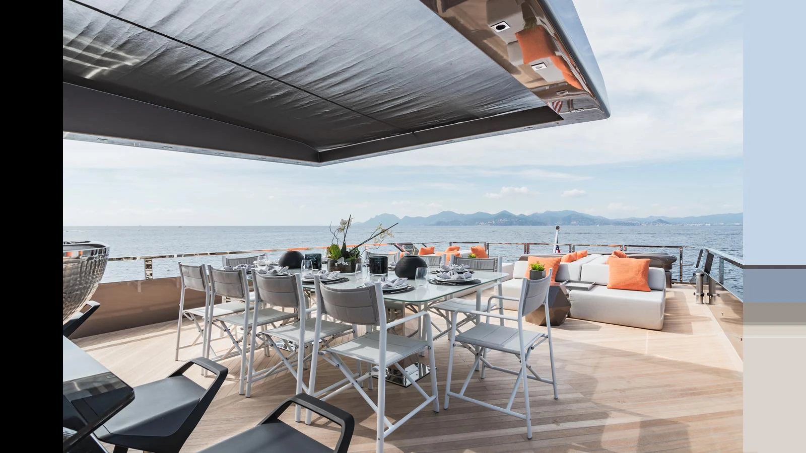 The aft deck features a spacious dining area with a large table and comfortable seating, perfect for alfresco dining with stunning sea views. aboard HULL #5 Yacht for Sale