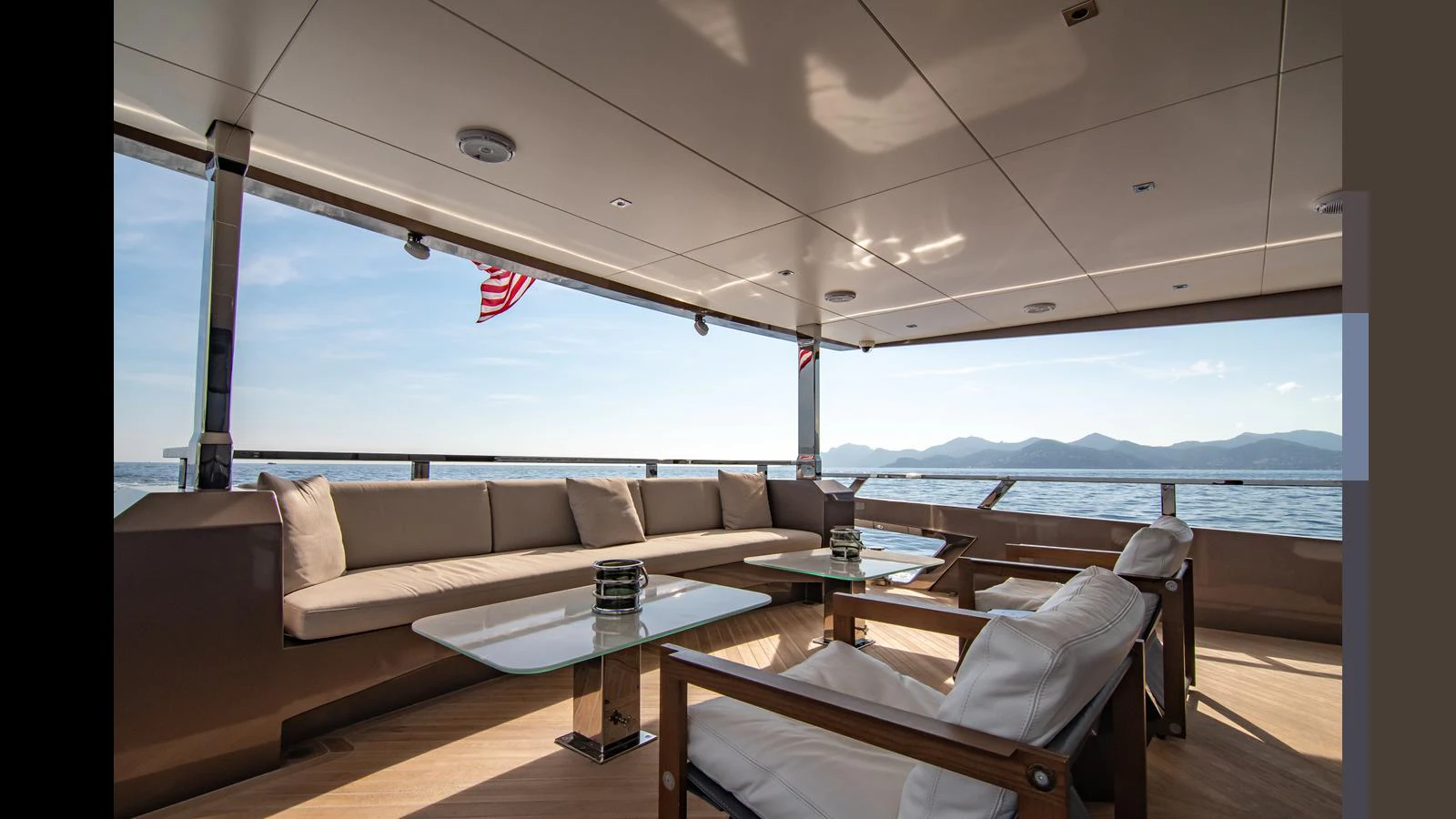 The aft deck offers a spacious and comfortable seating area with stunning ocean views. aboard HULL #5 Yacht for Sale