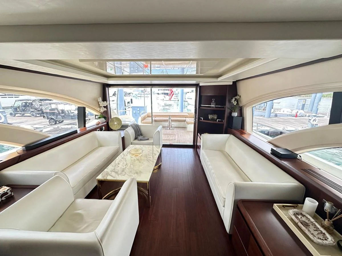 The salon features elegant seating with a view of the aft deck through large windows. aboard 75FT AZIMUT 2010, MINIMAL RISK Yacht for Sale