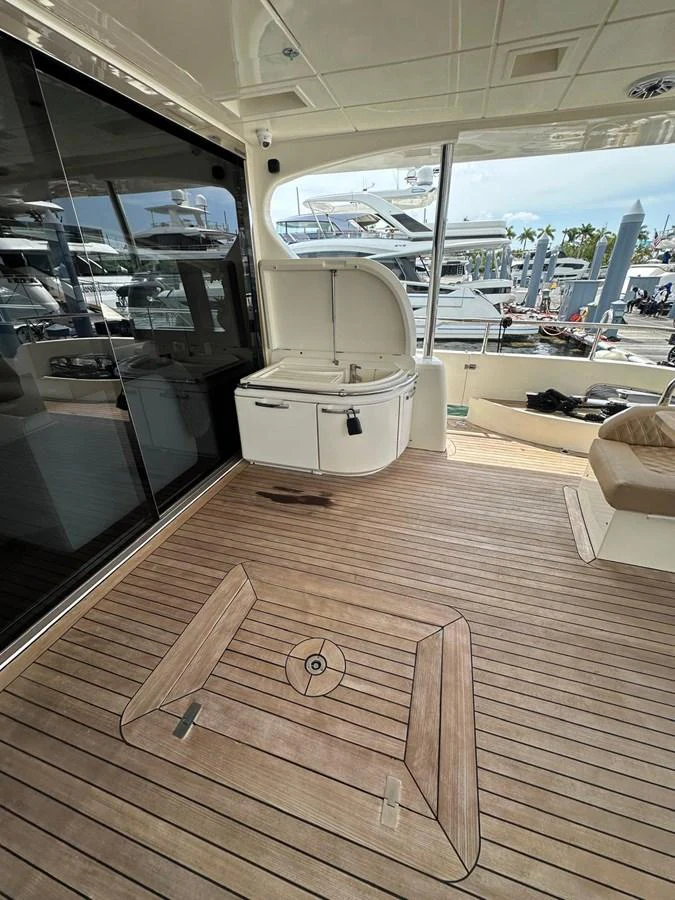 The aft deck features a clean, spacious area with a built-in sink and ample seating, perfect for relaxation and entertaining. aboard 75FT AZIMUT 2010, MINIMAL RISK Yacht for Sale
