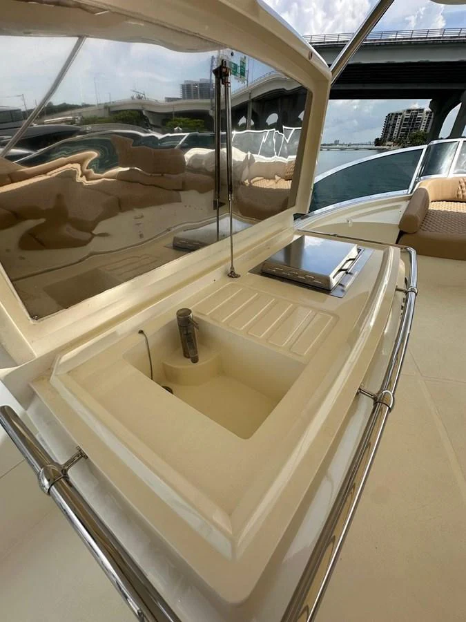 The yacht features a sleek outdoor galley with a sink and a grill, perfect for alfresco dining. aboard 75FT AZIMUT 2010, MINIMAL RISK Yacht for Sale