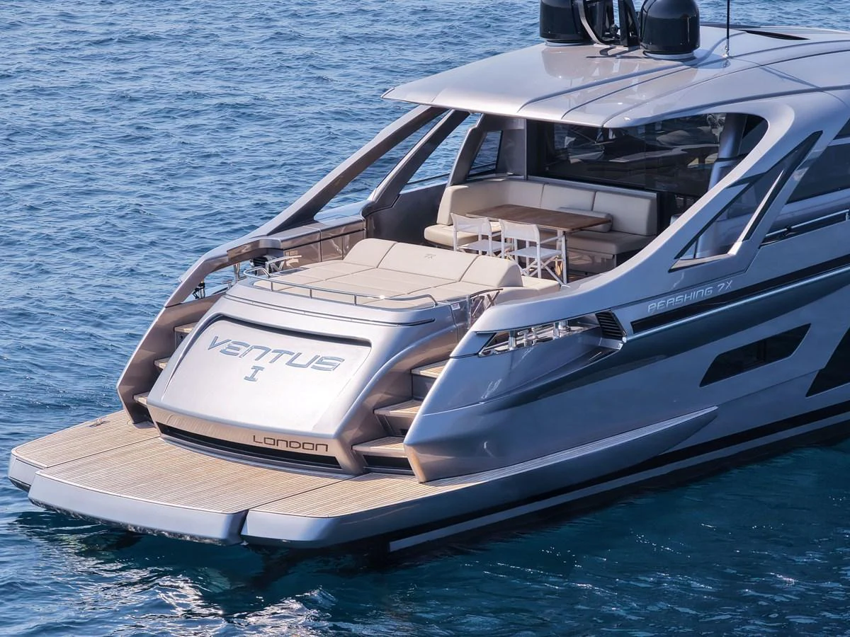 The sleek aft deck of this modern yacht features a spacious seating area and a dining table, perfect for alfresco dining. aboard VENTUS 1 Yacht for Sale