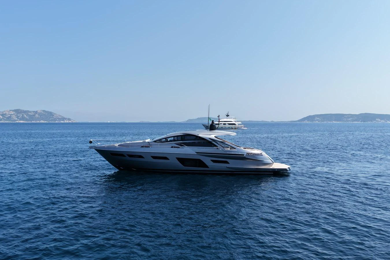 A sleek and modern yacht glides gracefully on calm blue waters with a scenic backdrop. aboard VENTUS 1 Yacht for Sale