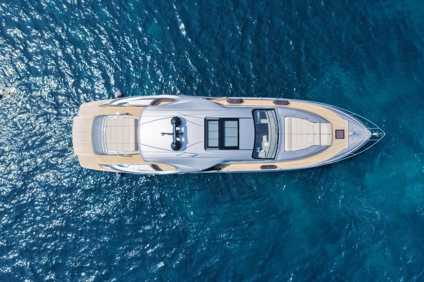 A sleek yacht glides effortlessly over the deep blue sea, showcasing its elegant design from an aerial perspective. aboard VENTUS 1 Yacht for Sale