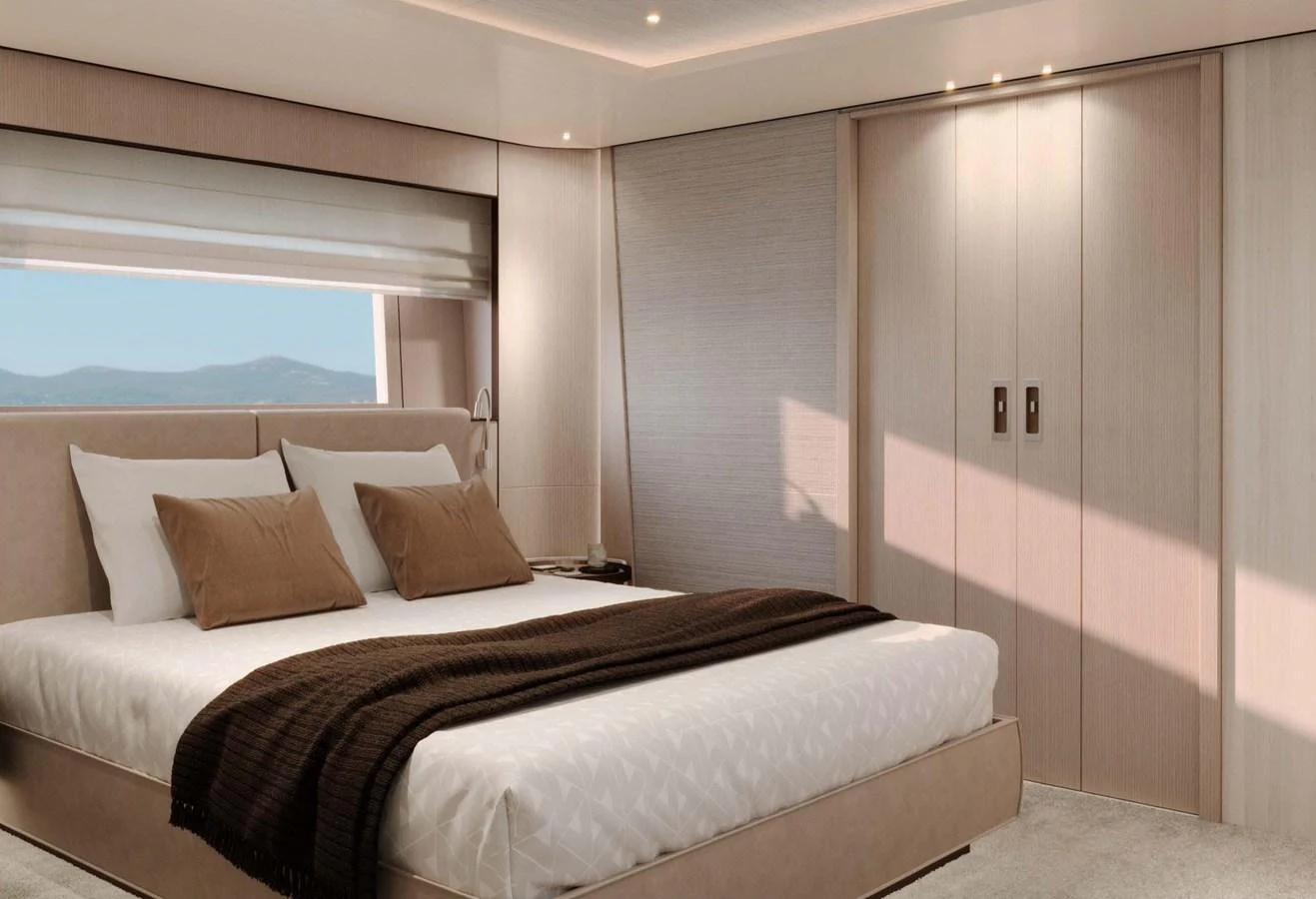 The stateroom features a luxurious bed with elegant bedding and ample natural light. aboard LUMINA Yacht for Sale