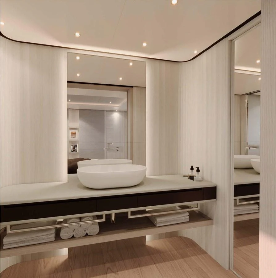 The yacht's bathroom features a sleek, modern design with a vessel sink and ample lighting. aboard LUMINA Yacht for Sale