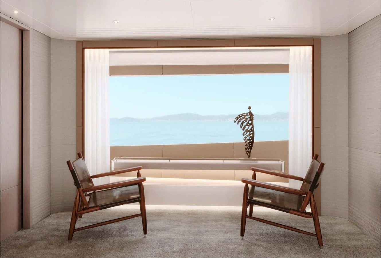 A serene interior space featuring two modern chairs facing a large window with a stunning ocean view. aboard LUMINA Yacht for Sale