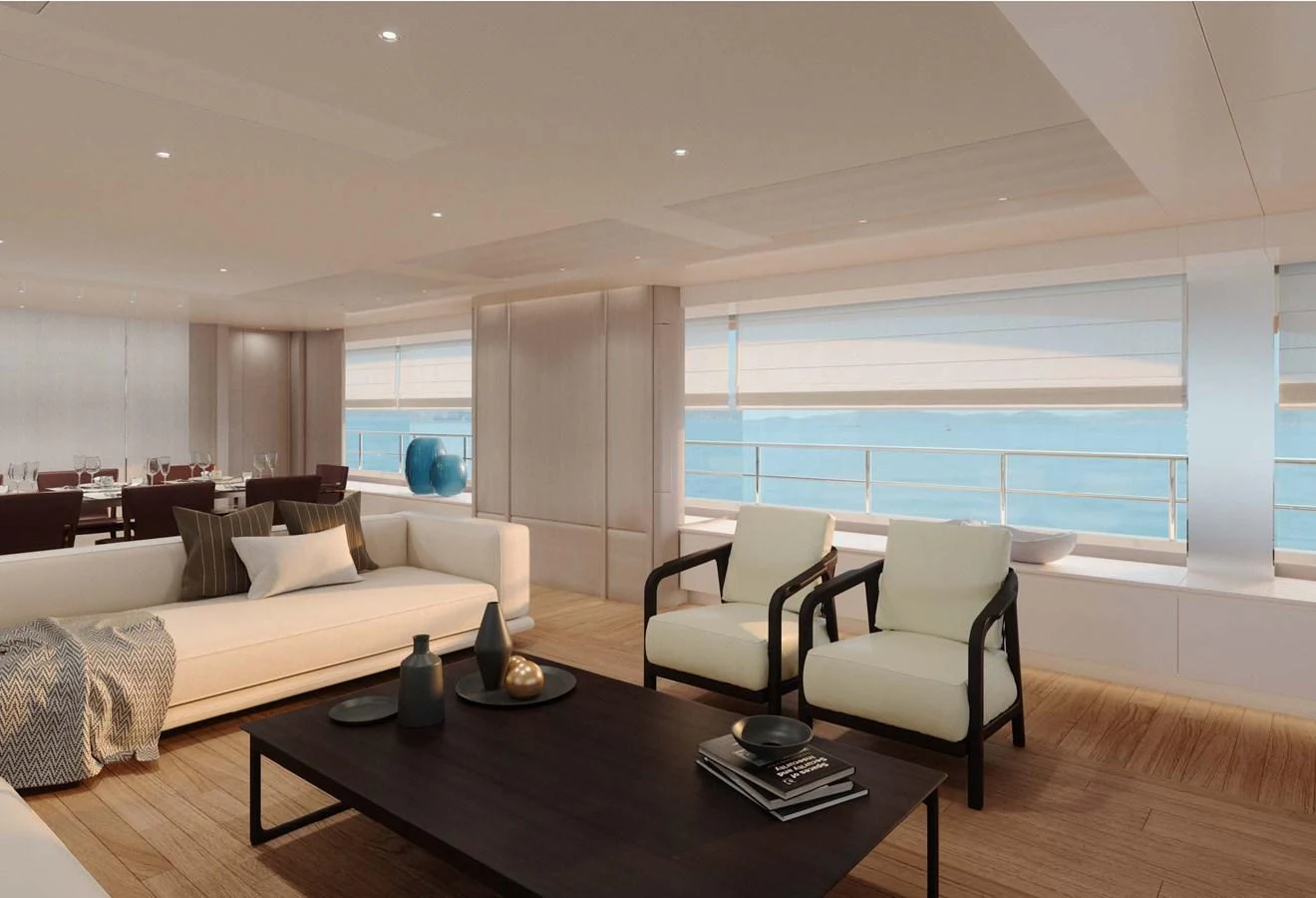 The spacious salon features elegant seating and large windows offering stunning ocean views. aboard LUMINA Yacht for Sale