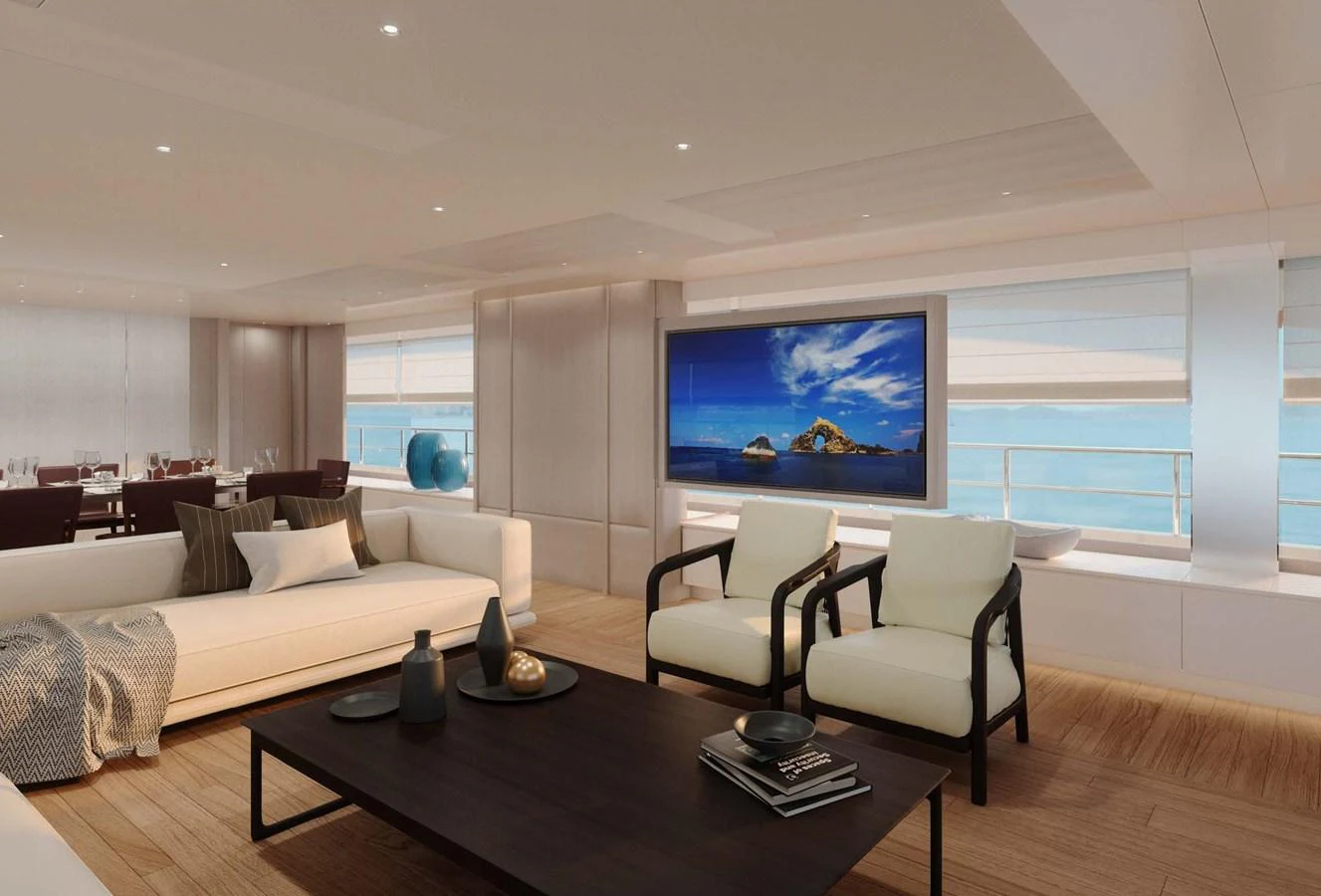 The salon features elegant seating with a large flat-screen TV and expansive windows offering stunning ocean views. aboard LUMINA Yacht for Sale