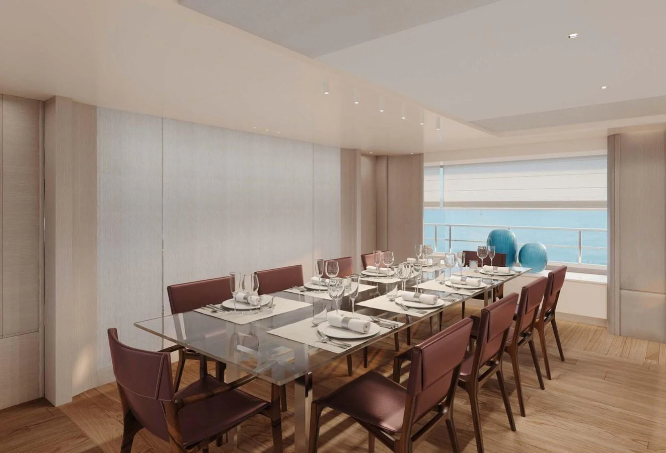 The elegant dining area features a large glass table set for a formal meal, with ample seating and a view of the sea. aboard LUMINA Yacht for Sale