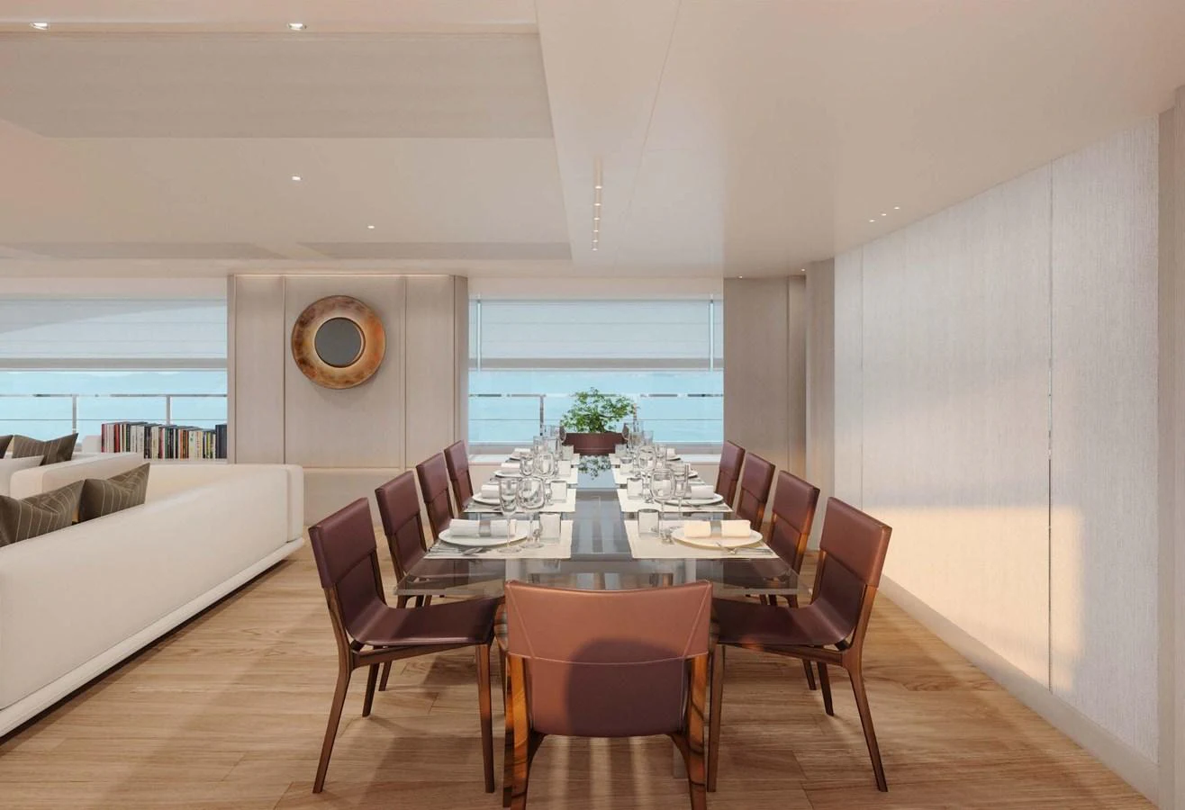 The yacht's dining area features a sleek, modern design with a large table and comfortable seating. aboard LUMINA Yacht for Sale