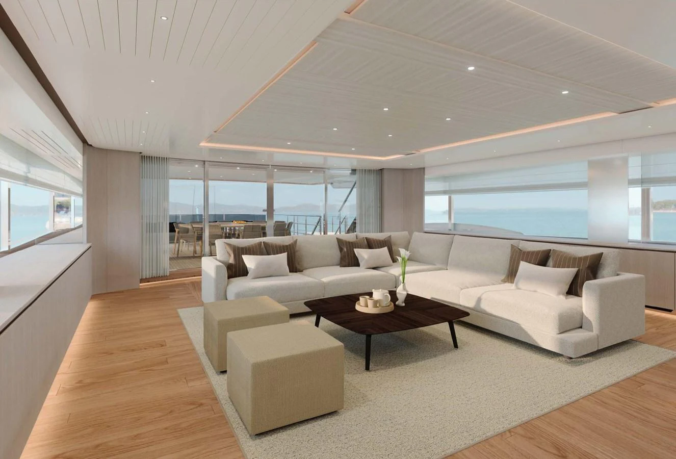 The spacious salon features modern furnishings and expansive windows offering stunning ocean views. aboard LUMINA Yacht for Sale