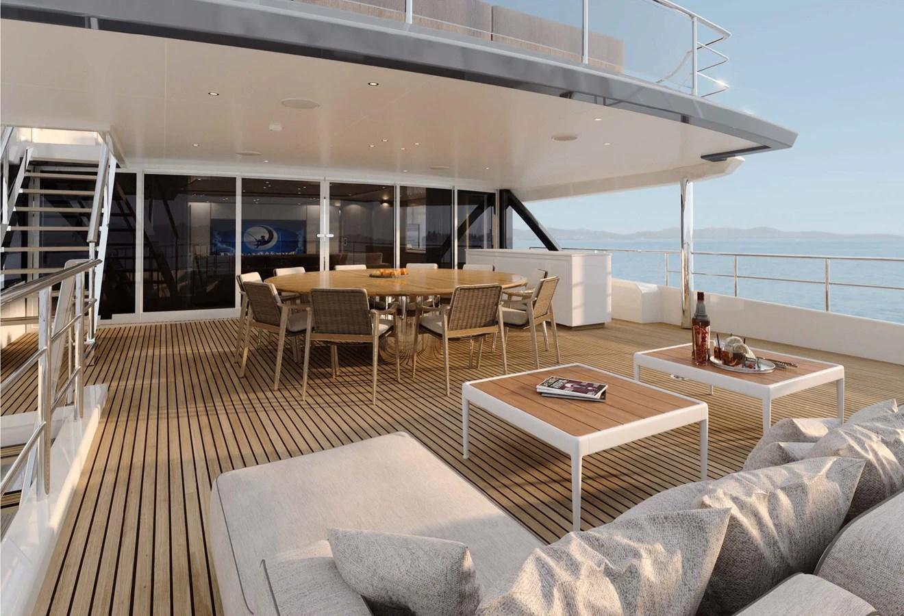 The aft deck features a spacious seating area with a dining table and comfortable lounge furniture, perfect for outdoor relaxation and dining. aboard LUMINA Yacht for Sale