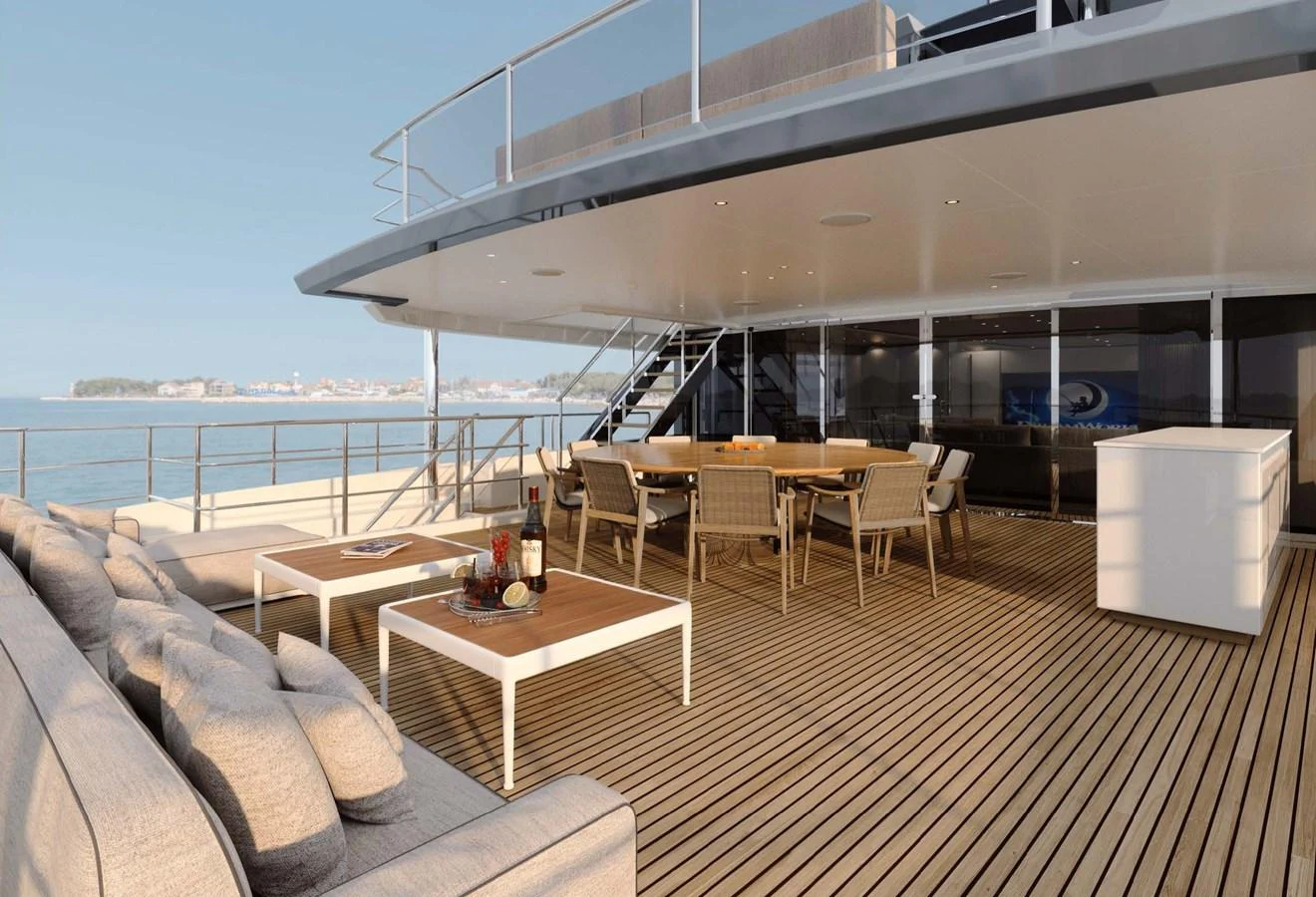The spacious aft deck offers a luxurious outdoor dining and lounging area with stunning ocean views. aboard LUMINA Yacht for Sale