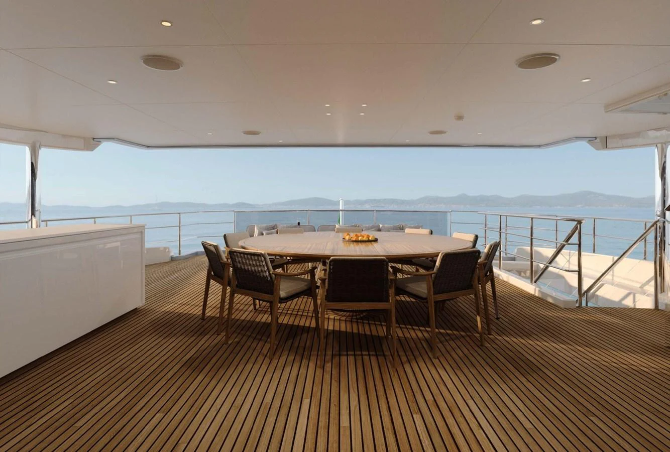 The aft deck features a spacious dining area with panoramic ocean views. aboard LUMINA Yacht for Sale