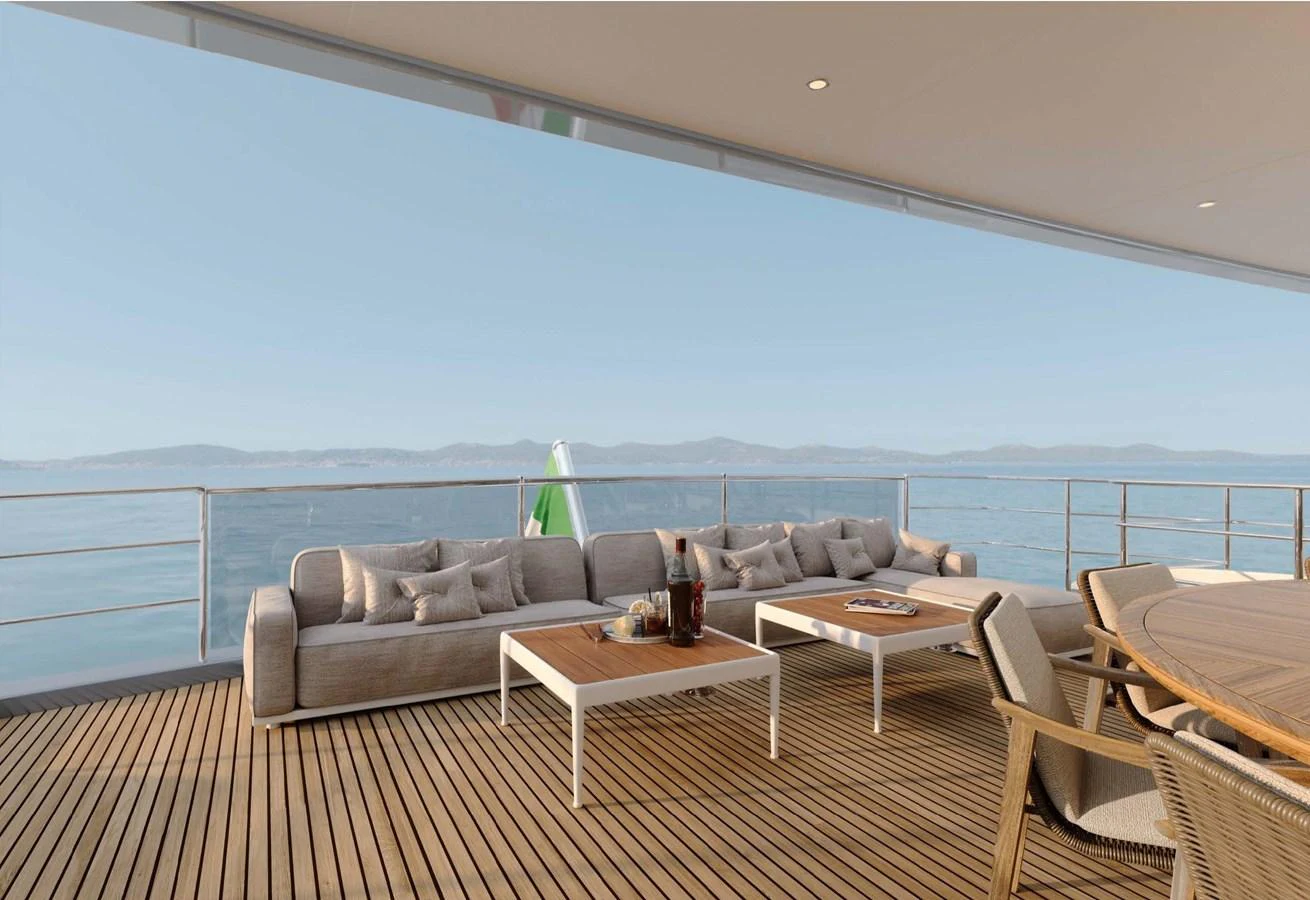 The aft deck features a spacious seating area with comfortable sofas and a dining table, perfect for relaxing and enjoying the sea view. aboard LUMINA Yacht for Sale