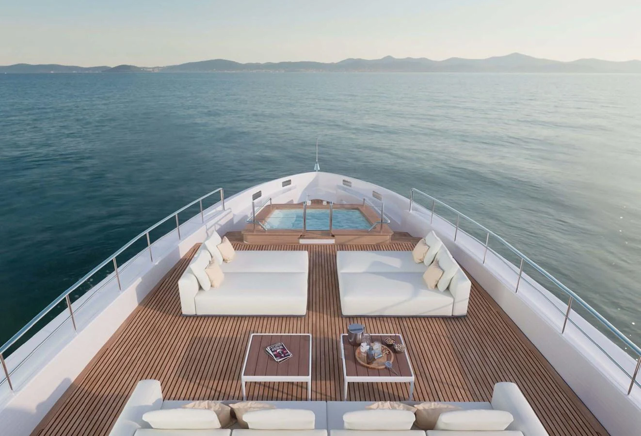 The foredeck features luxurious sun loungers and a jacuzzi, offering a serene space to relax and enjoy the ocean views. aboard LUMINA Yacht for Sale