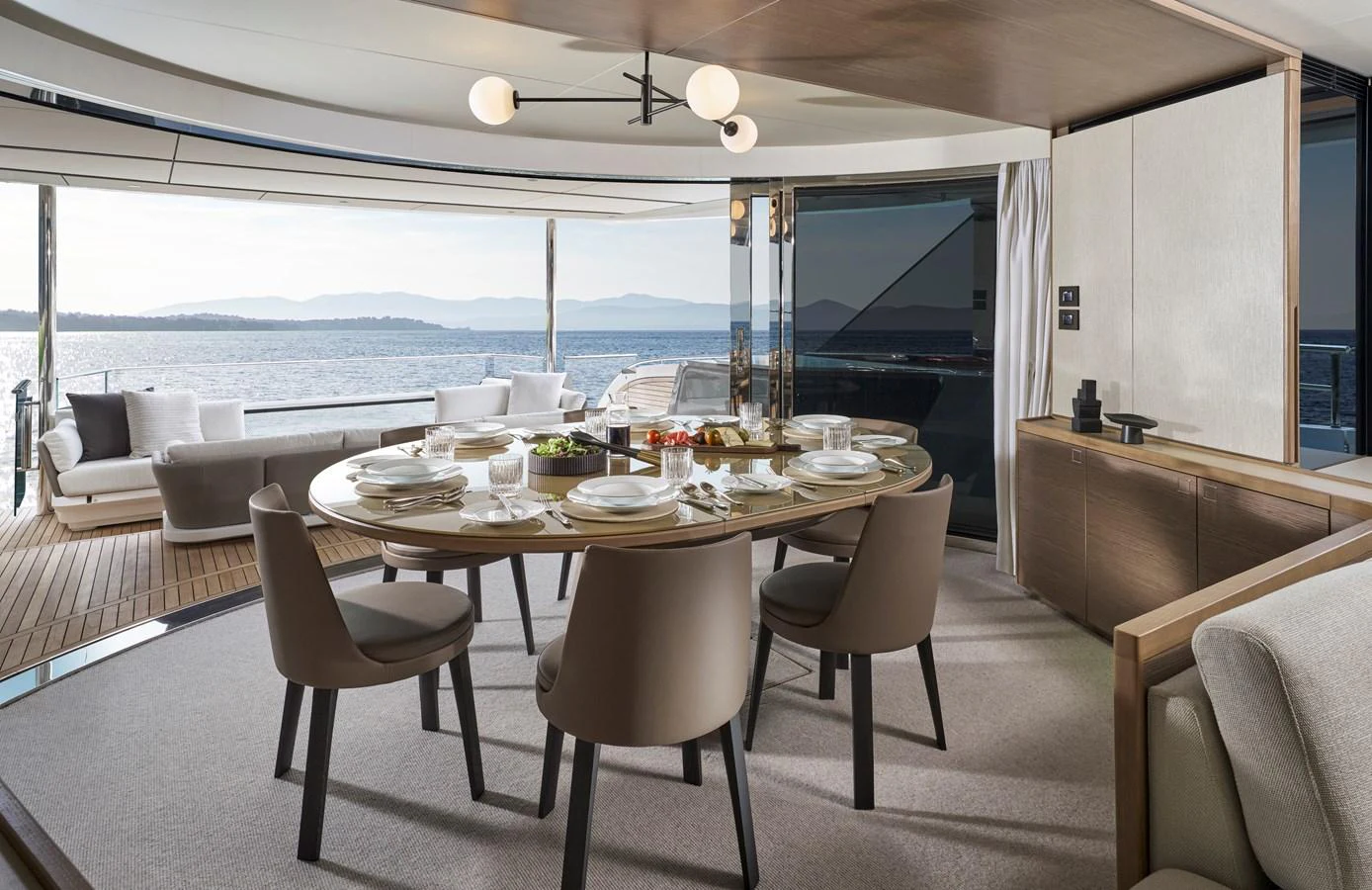 The yacht's dining area offers a luxurious setting with a stunning view of the sea. aboard PRINCESS X90 Yacht for Sale