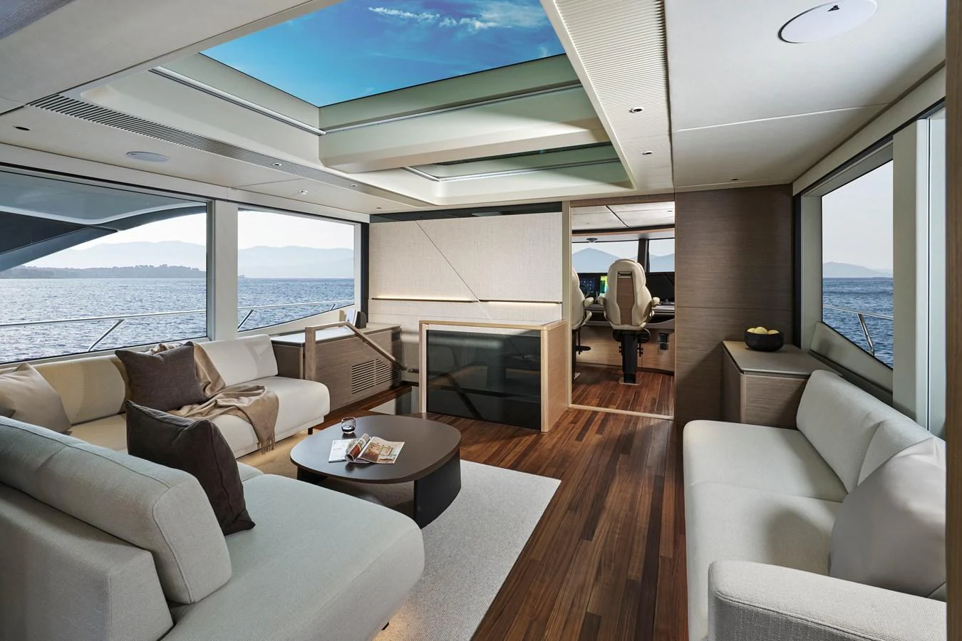 The salon features luxurious seating with panoramic windows and a skylight, offering a spacious and elegant living area. aboard PRINCESS X90 Yacht for Sale