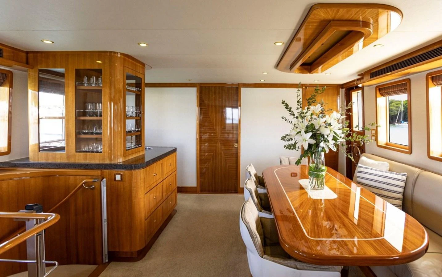 The yacht's dining area features elegant wood finishes and ample natural light. aboard ODYSSEY Yacht for Sale