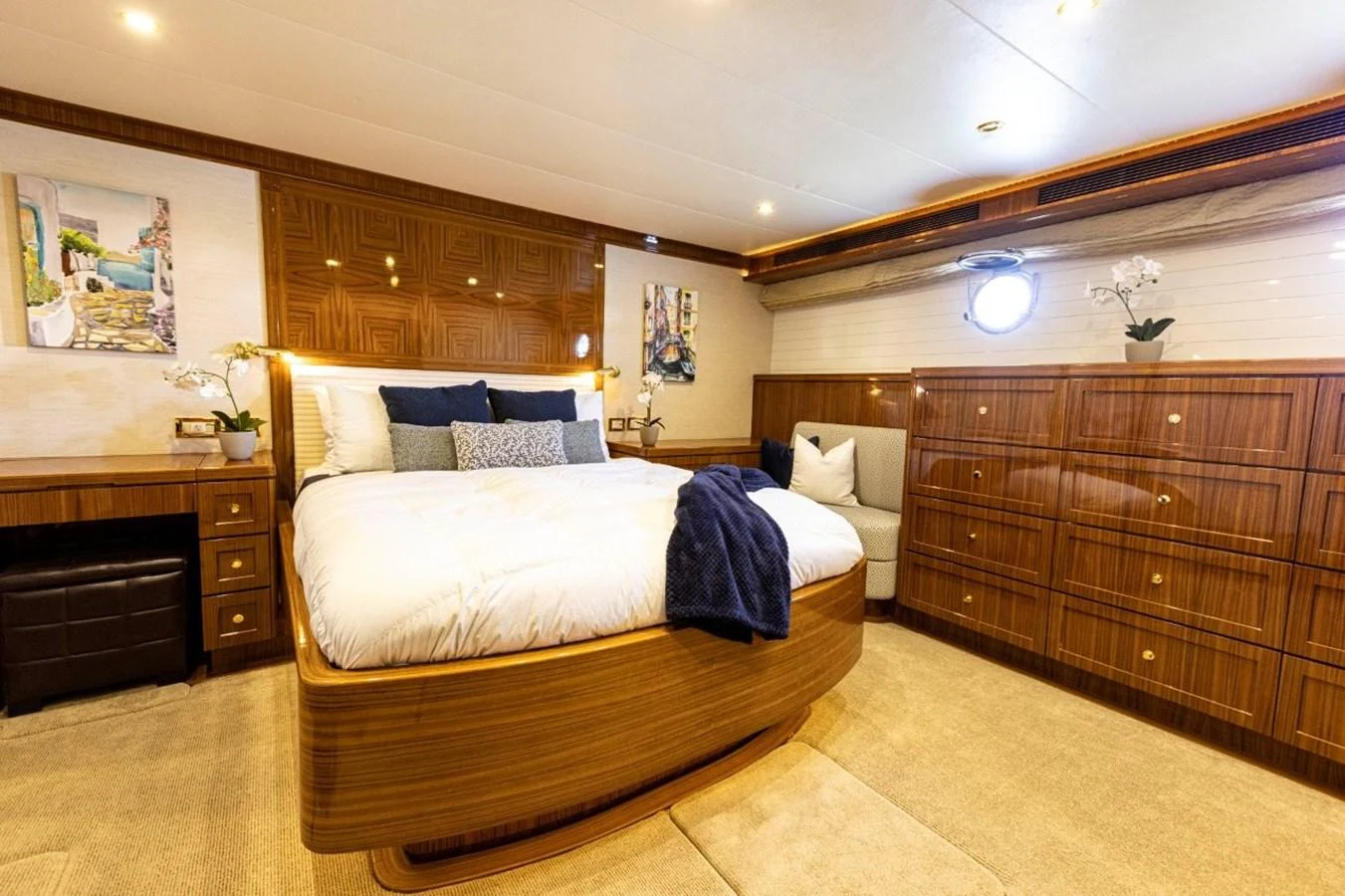 The master stateroom features a luxurious bed, elegant wood finishes, and tasteful decor. aboard ODYSSEY Yacht for Sale