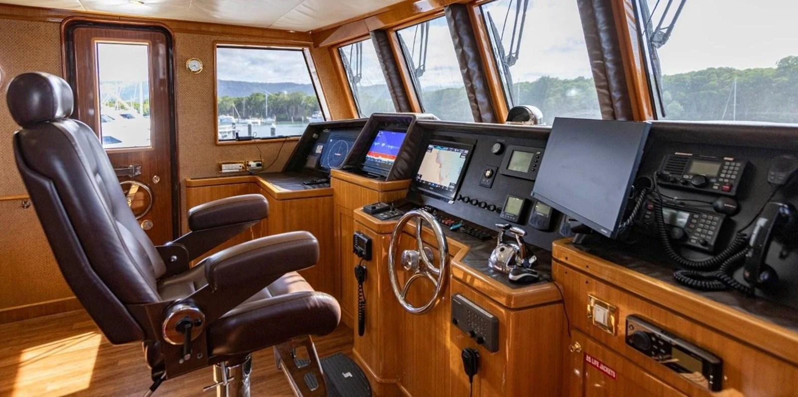 The helm station features advanced navigation equipment and a comfortable captain's chair, offering a commanding view for smooth sailing. aboard ODYSSEY Yacht for Sale