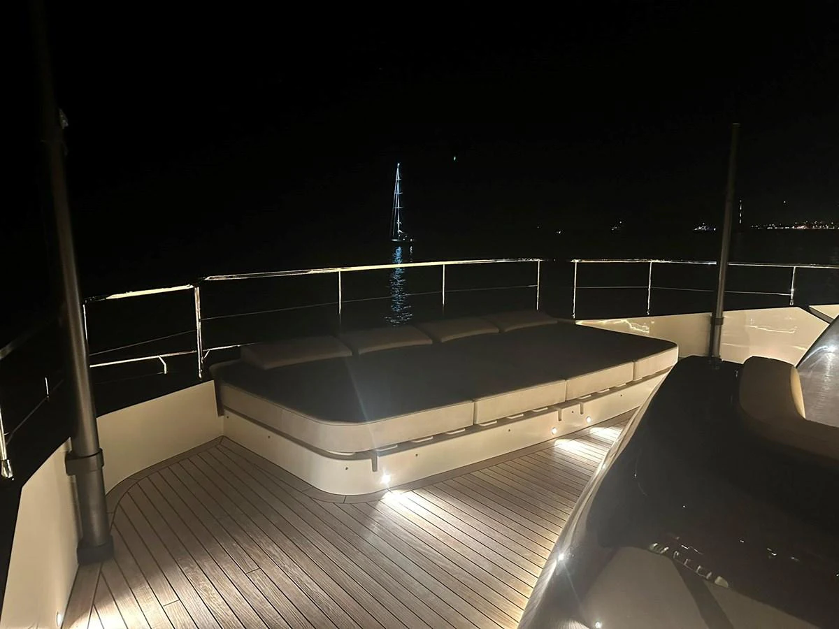 The yacht's deck is elegantly illuminated at night, offering a serene and inviting atmosphere. aboard ATALI Yacht for Sale