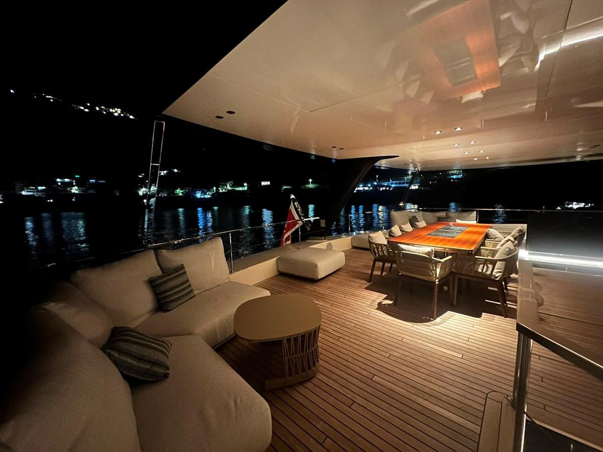 The aft deck offers a cozy and inviting space with plush seating and a dining area, perfect for evening relaxation. aboard ATALI Yacht for Sale