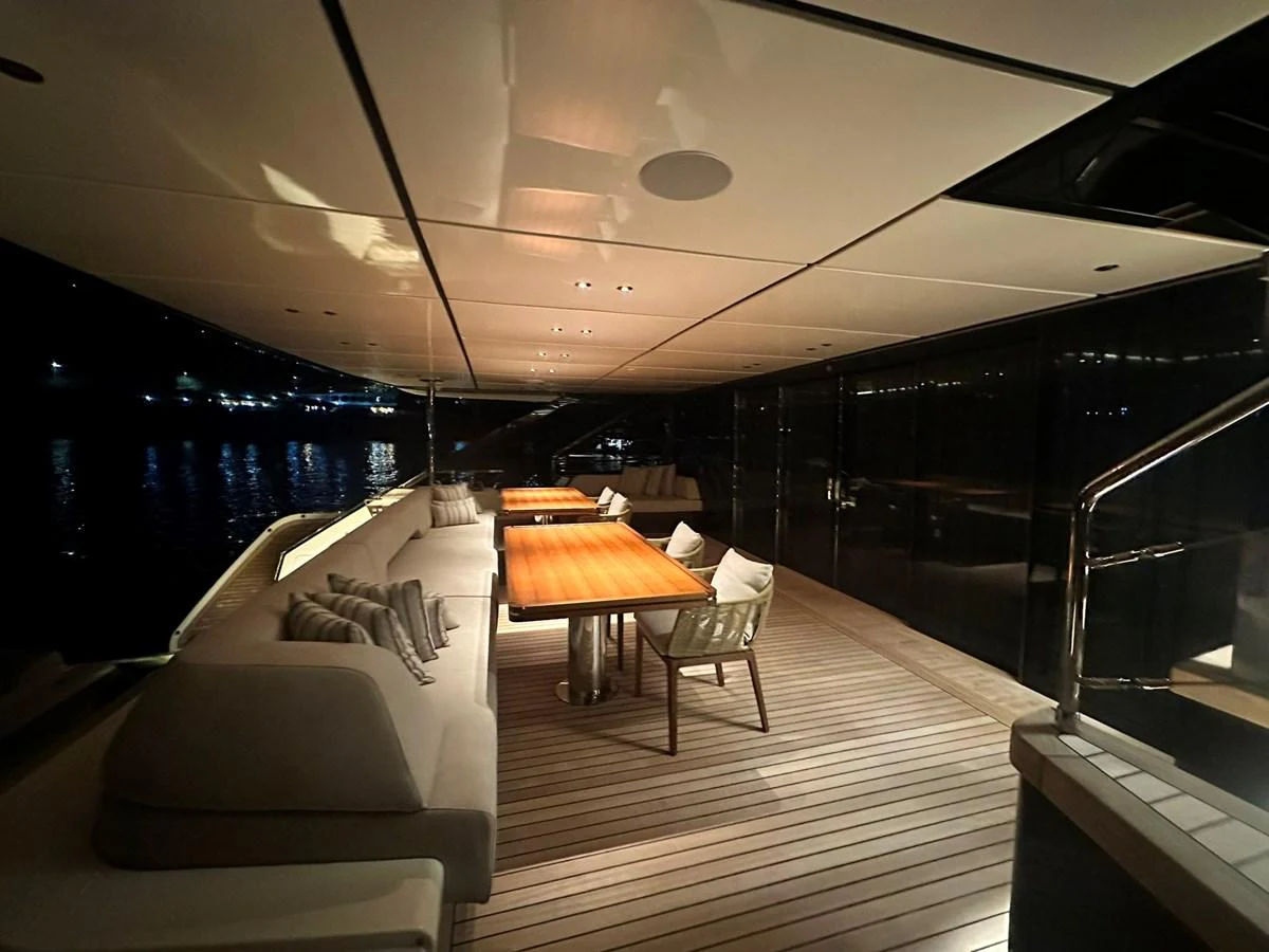 The aft deck features elegant seating and dining areas under a sleek, modern ceiling. aboard ATALI Yacht for Sale