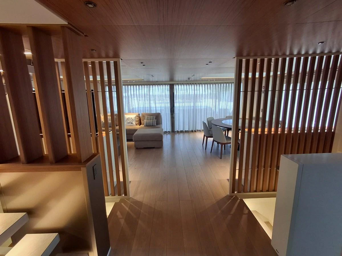 The yacht's interior features a spacious and elegantly designed living area with ample natural light. aboard ATALI Yacht for Sale