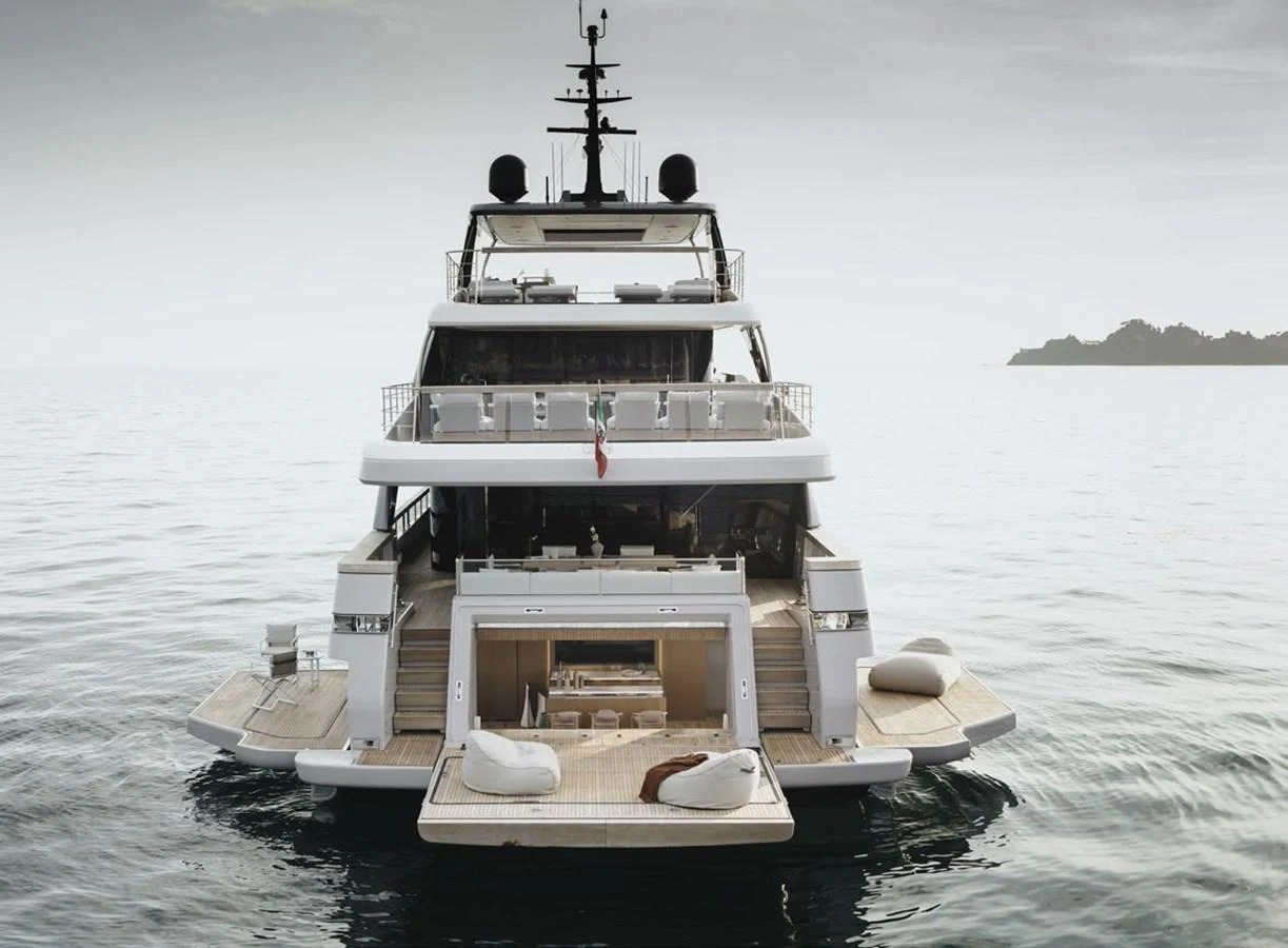 The yacht's aft deck features luxurious lounging areas and a spacious swim platform, perfect for relaxation and water activities. aboard TOO COOL Yacht for Sale