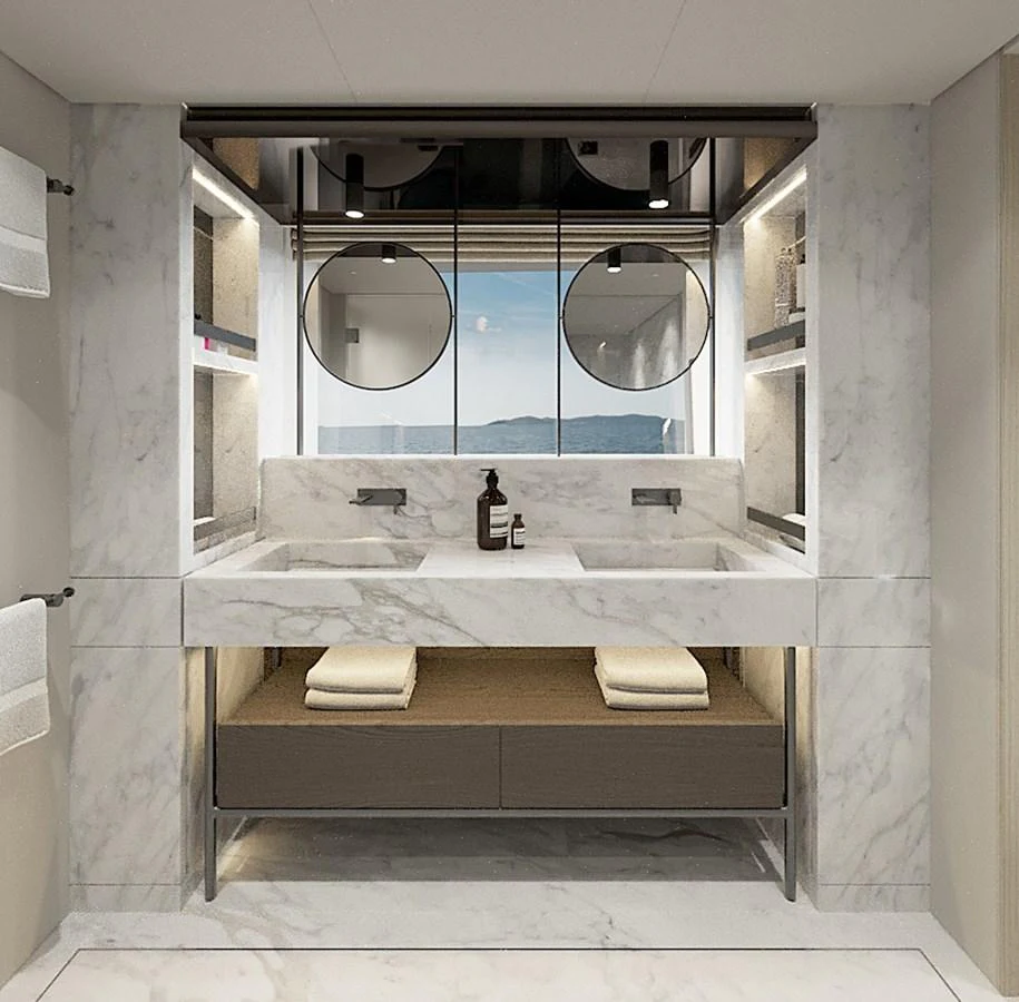 The yacht's bathroom features a luxurious marble design with dual sinks and a scenic view. aboard TOO COOL Yacht for Sale